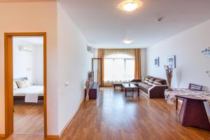 a living room with a couch and a table at Edmond Apartment-Highspeed-Internet-Free! in Aheloy +62 photos