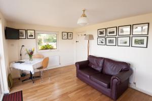 a living room with a couch and a table at The Wild Atlantic Hideaway in Clonakilty