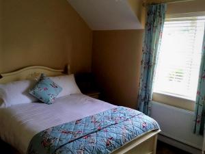 a small bedroom with a bed with a window at Greenway View B&B in Newport