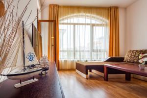 a living room with a couch and a table at Edmond Apartment-Highspeed-Internet-Free! in Aheloy