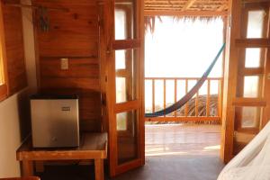 a room with a door to a room with a balcony at Cafe Maya - Casa Acalli in Zipolite