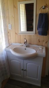 a white sink sitting under a mirror in a bathroom at Wolfwood Guest Ranch in Clearwater