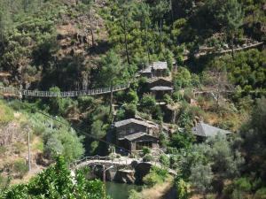 a suspension bridge over a river on a mountain at Casa da Eira in Cerdeira