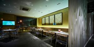 a restaurant with tables and chairs in a room at d'Sora Boutique Business Hotel in Kampong Baharu Jimah +20 photos