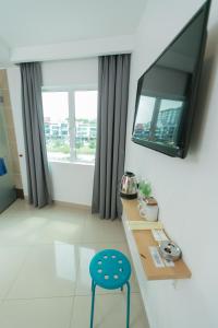 a room with a table and a chair and a mirror at 1 Hotel Mahkota Cheras in Kuala Lumpur