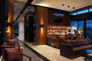 a bar in a hotel with people sitting at a bar at Serenotel Pattaya in Pattaya Central