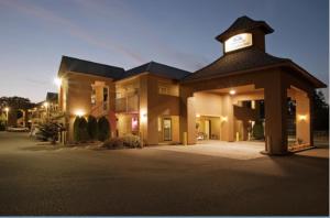 a large building with a clock on top of it at Americas Best Value Inn Lakewood South Tacoma in Lakewood