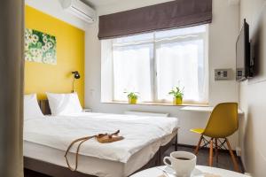 a hotel room with two beds and a yellow wall at Live hotel by Original Hotels in Yekaterinburg