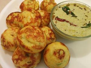 a plate of food with a bowl of dipping sauce at Hotel RR International in Bangalore +24 photos