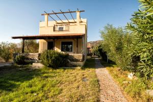 a small house with a window and a balcony at Villas Paleochora in Palaiochóra +21 photos