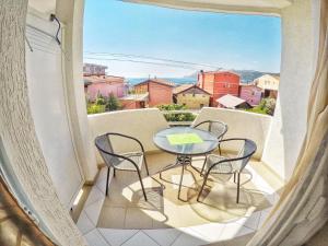 a balcony with a table and chairs and a view at Studios Seaview in Dobra Voda