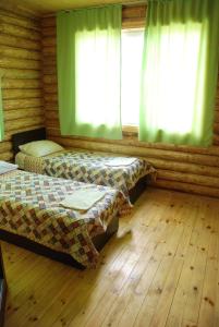 Posteľ alebo postele v izbe v ubytovaní Guest house Ozernaya