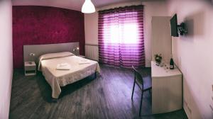 Postel nebo postele na pokoji v ubytování Hotel Risorgimento