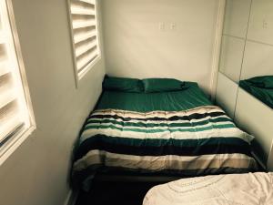 a small room with a bed in the corner at Luxury Two Story Villa Unit C in Laval