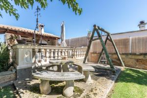 a park with picnic tables and a swing at Villa Marina in Playa de Palma in Palma de Mallorca