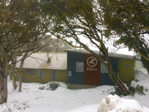 a building with a sign on it in the snow at Gliss Ski Club in Mount Buller