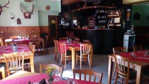 a restaurant with tables and chairs with pink tablecloths at Penzion Edelštejn in Petrovice