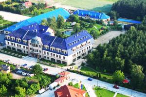 an overhead view of a large building with a blue roof at Hotel Park Kajetany in Nadarzyn