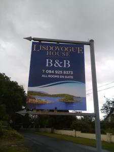 a sign for a house on the side of a road at Lisduvogue House in Ballina