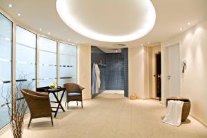 a hallway with a table and chairs in a building at Hotel Sonne in Rheda-Wiedenbrück