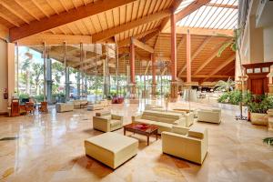 a lobby with couches and tables in a building at Hipotels Natura Palace Adults Only in Playa Blanca
