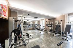 a gym with several tread machines in a room at La Casa del Mulino in Merone