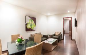a waiting room with a table and chairs at The Lotus Apartment Hotel, Venkatraman Street in Chennai