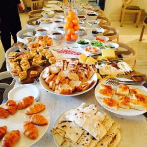 a long table filled with plates of food at Kar's Hotel in Kars