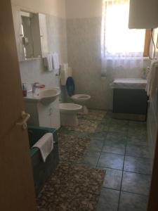 a bathroom with a sink and a toilet and a window at Toni i Kristina in Baška +84 photos