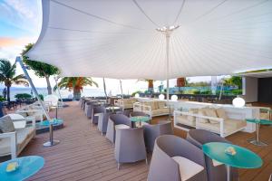 a restaurant with chairs and tables and an umbrella at Hipotels Natura Palace Adults Only in Playa Blanca