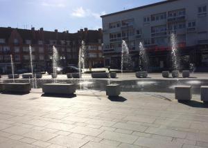 a courtyard with a fountain with trees and lights at Citadel Hôtel in Calais
