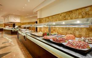 a buffet line with many different types of food at Hipotels Natura Palace Adults Only in Playa Blanca