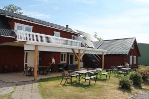 a patio with tables and chairs in front of a house at Trosa Vandrarhem in Trosa
