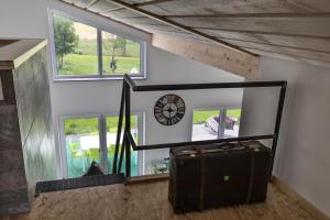 a room with a clock on the wall and a suitcase at Selke´s exklusives Ferienhaus in Clausthal-Zellerfeld