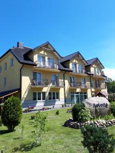 a large apartment building with a large yard at Asteria Odargowo in Krokowa