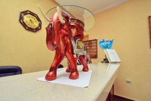 a red statue of an elephant on a counter at Hotel LeMan in Kabardinka