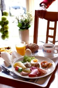 a plate of breakfast food on a table at Hotel Park Allé in Kristianstad
