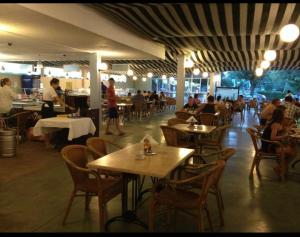 a restaurant with tables and people sitting at tables at HOTEL FELIX Eforie Nord in Eforie Nord