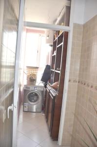 a laundry room with a washing machine and a window at Bri Apartment in Casablanca