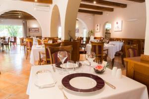 a dining room with white tables and chairs at Logis Auberge Bienvenue in Doué-la-Fontaine