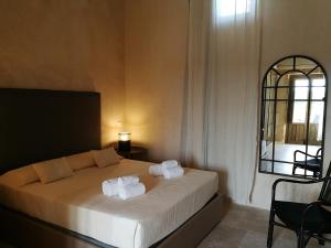 een slaapkamer met een bed met twee handdoeken erop bij Casette Marianeddi -Agriturismo Marianeddi in Noto
