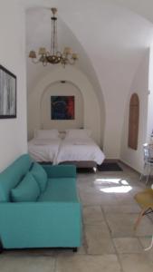 a living room with a couch and a bed at Legatia in Jerusalem