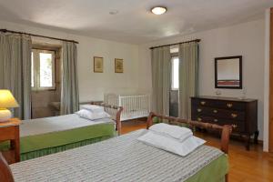a bedroom with two beds and a dresser at Quinta do Galgo in Amares +58 photos