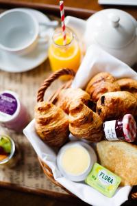 a basket of pastries and bread on a table at Malmaison London in London