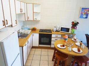 a small kitchen with a small table and a sink at Dumela Margate Flat No 2 in Margate