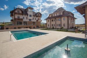 an estate with a swimming pool in front of a building at Zlatibor Hills in Zlatibor