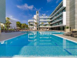 a swimming pool in front of a building at H10 Casa del Mar in Santa Ponsa