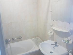 a bathroom with a sink and a toilet and a mirror at Hotel El Layeli in Sfax