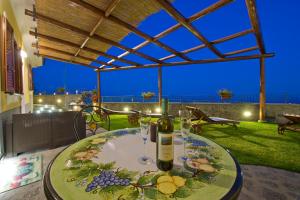 un tavolo con bottiglie di vino e bicchieri su un patio di La Mela Blu a Furore