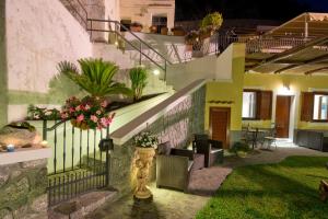 a house with stairs and plants in the yard at La Mela Blu in Furore
